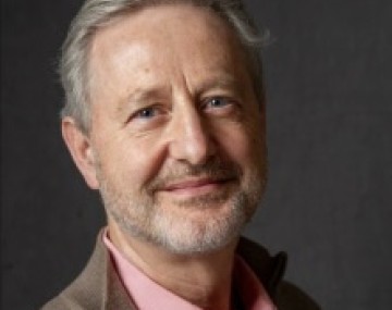 Man smiling wearing a button down shirt